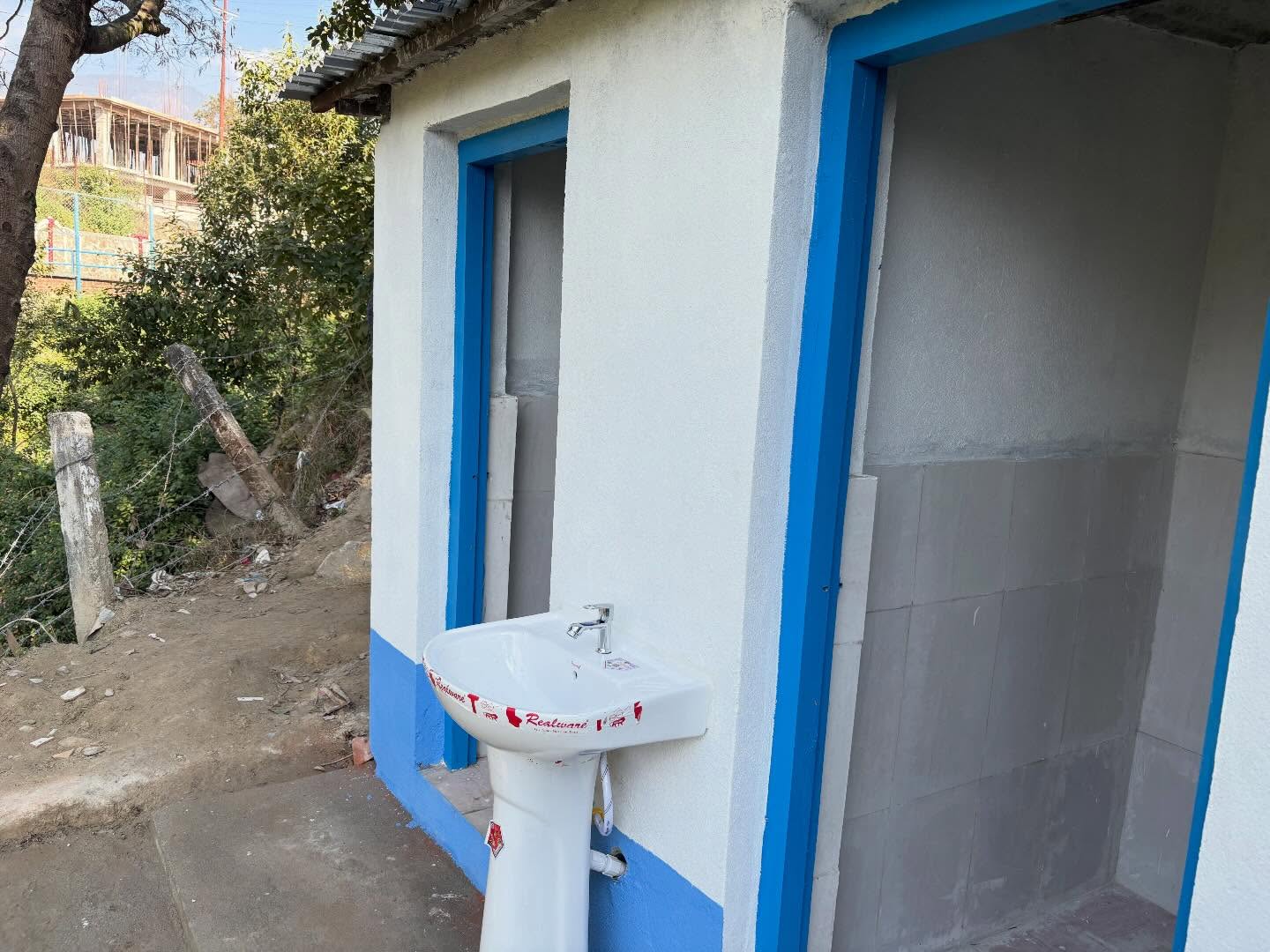Construction of a toilet building at Dharmasthali Police Post and assistance with computers and printers.